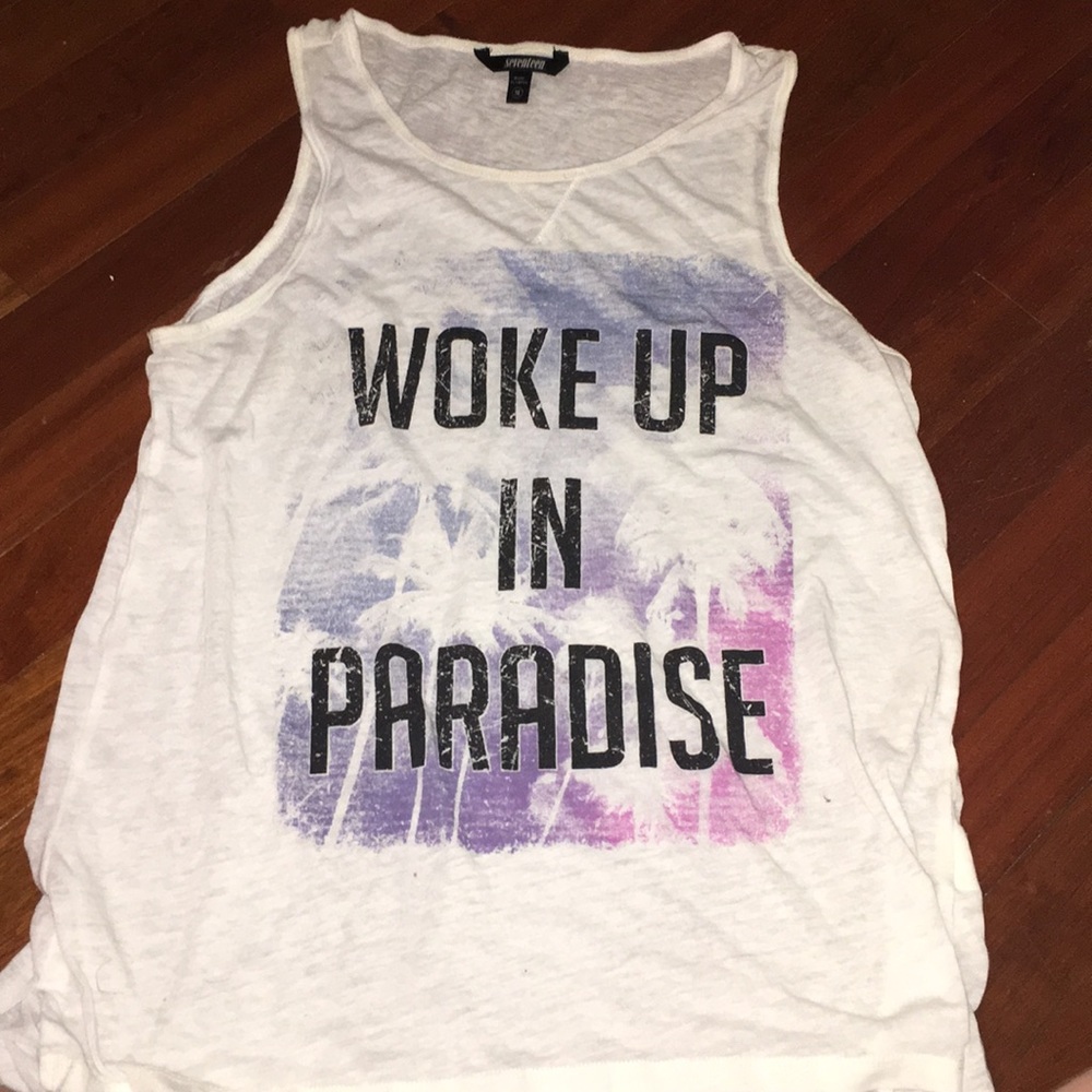 White “WOKE UP IN PARADISE” muscle tee.